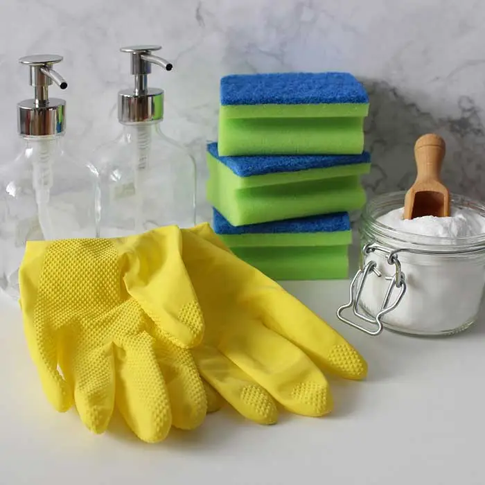 An assortment of pest control cleaning supplies and tools on a white table